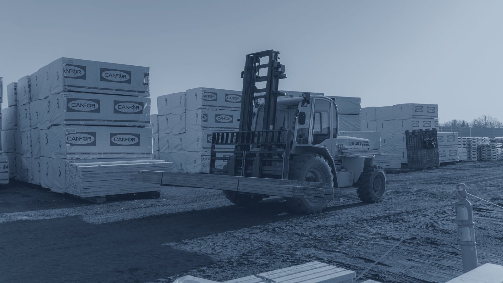 A forklift moving lumber in the yard