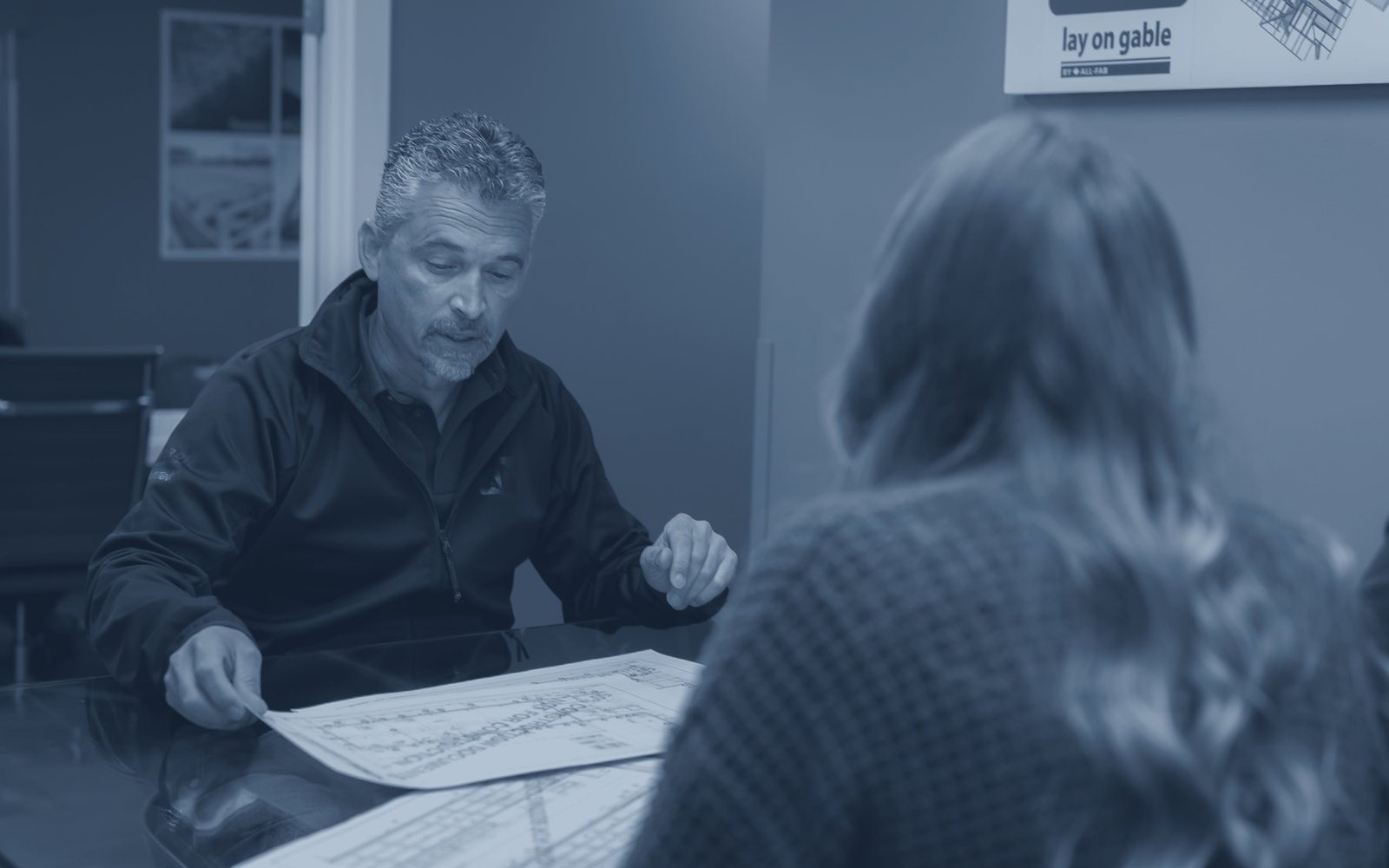 A sales meeting over drawings